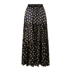 Detailed view of black tiered maxi skirt with golden polka dot print and elastic waist