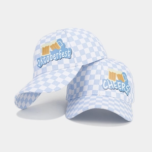 Close-up of blue and white checkered baseball hats with Oktoberfest and Cheers embroidery