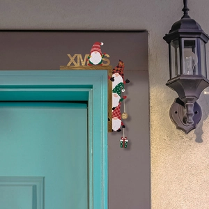 Detailed view of a wooden Christmas door frame decor featuring Gnome silhouettes and XMAS text