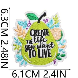 Detailed view of pear-shaped embroidery patch with size markers 6.3cm by 6.1cm