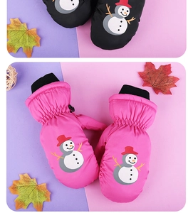 Detail view of pink and black waterproof kids ski mittens with a cute snowman pattern