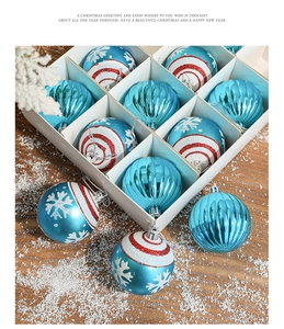 Blue Christmas ball ornaments in box with striped textures and snowflake patterns on wood