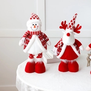 Close-up of plush Christmas snowman and reindeer dolls with detailed knitted textures