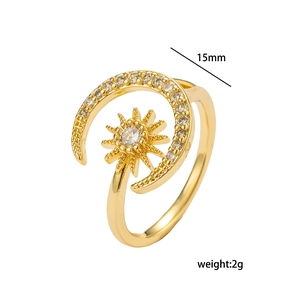 Adjustable golden sun and moon open ring with sparkling zircon stones on white background