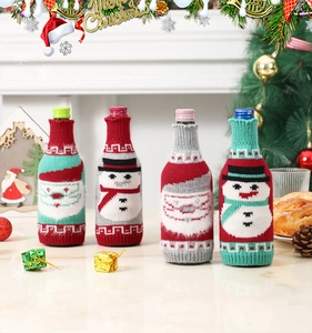 Detail of Christmas knitted wine bottle covers with cute Santa and Snowman cartoon patterns
