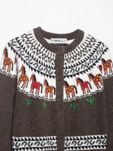 Detail of vintage Fair Isle knit cardigan with horse embroidery and geometric pattern