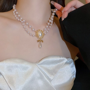 French retro double-layer pearl necklace with a golden bow and water drop pendant