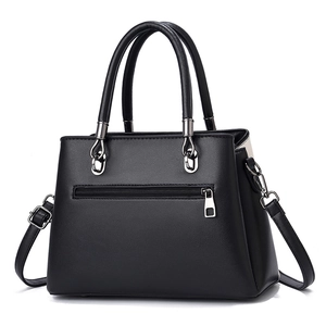 Minimalist black leather handbag with silver hardware and adjustable shoulder strap