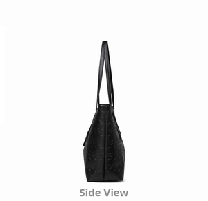 Side view of black tote bag featuring detailed skull embossed texture and structured design