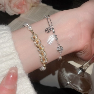 Close-up of elegant zircon copper coin and pearl bracelets for women with chic details