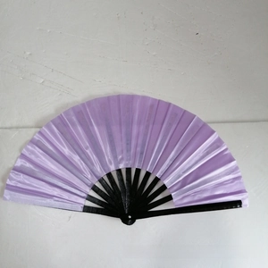 Detailed view of an open purple fabric folding fan with glossy black bamboo ribs