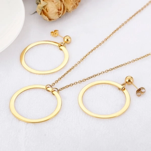 Elegant gold hollow geometric circle necklace and earrings jewelry set on white fabric