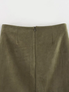Detailed close-up of dark green faux suede skirt waist with invisible zipper