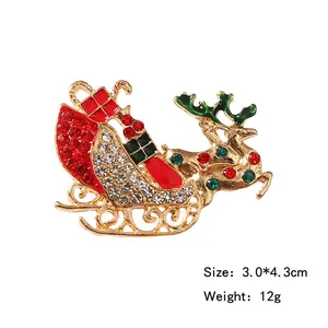 Christmas reindeer sleigh brooch with rhinestones and enamel on white background