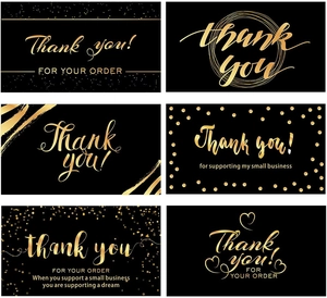 Macro view showing six elegant black and gold thank you business card designs