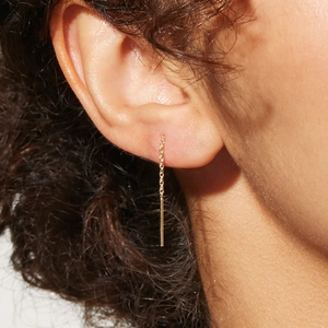 Close-up of minimalist S925 silver gold-plated chain earrings with hanging bar on model