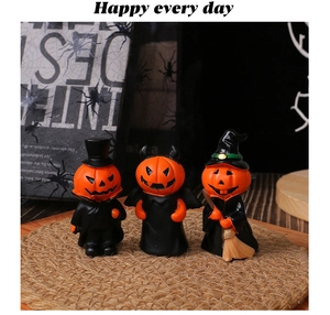 Three Halloween resin pumpkin figurines with vampire, devil, and witch themes on a woven mat