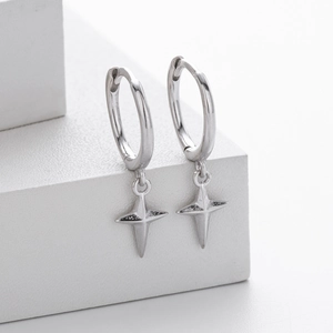 Close-up of S925 sterling silver hoop earrings featuring four-pointed star pendants