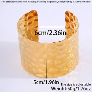 Detailed view of wide hammered gold bangle showing 5cm width and adjustable opening