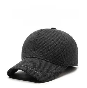 Detail of dark gray fleece-lined baseball cap with waffle texture and ear protection