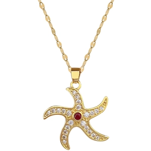 Gold starfish necklace with white pave crystals and central red gem on thin chain