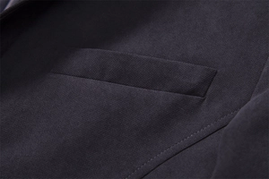 Detailed view of the dark grey wool coat pocket with fine stitching and woven texture