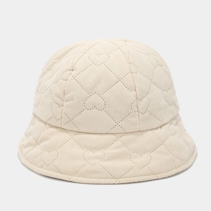 Detail of cream white bucket hat with heart-shaped quilting and textured fabric