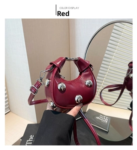 Detail view of mini wine red leather handbag with decorative silver dome rivets