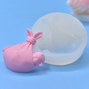 Sleeping baby pig silicone mold for DIY fondant and plaster crafts on blue background