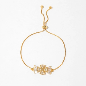 Detailed shot of adjustable gold bracelet featuring crystal cross and box chain clasp