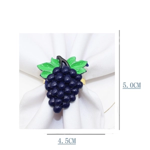 Detailed view of grape napkin ring with purple beads and green leaves, 5.0cm x 4.5cm