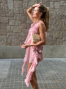 Detailed view of layered pink ruffled chiffon texture on sleeveless summer top