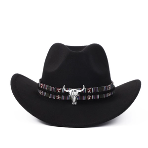 Détail du chapeau de cowboy noir avec ruban ethnique tissé et breloque tête de taureau argent