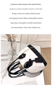 Detail of a black and white quilted handbag with golden chain strap on a reflective surface