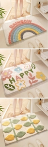 Detailed views of soft absorbent bathroom mats with rainbow, flower, and leaf patterns