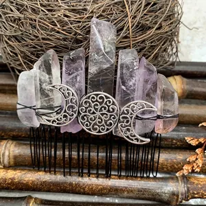 Detail of handcrafted amethyst hair comb with crescent moon and wire-wrapped crystals
