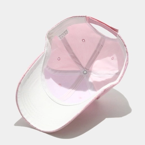 Detailed interior of glitter baseball cap showing the 100% polyester fabric label