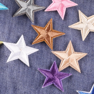 Colorful star-shaped embroidered patches on blue denim fabric for DIY clothing decor