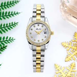 Close-up of quartz watch with crystal bezel, date display, and two-tone metal strap