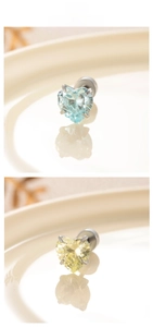 Detail of 6mm heart zircon stud earrings in light blue and yellow with titanium steel base