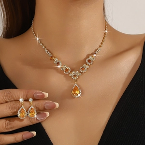 Detail of luxury bridal jewelry set with amber teardrop stones and crystal accents