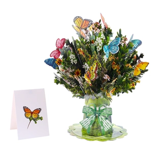 Macro detail of 3D pop-up flower bouquet card with colorful paper butterflies and green bow