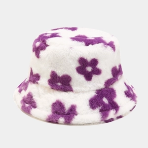 Close-up of soft plush texture on white bucket hat with purple flower pattern