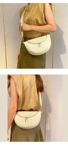 Chic beige half-round leather crossbody bag with dual metal zippers and wide strap detail