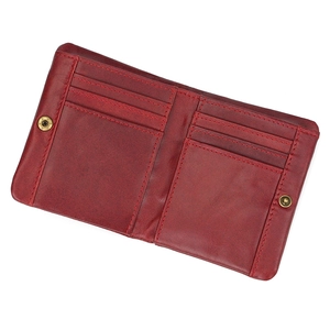 Detail view of red leather wallet interior with symmetrical card slots and snap buttons