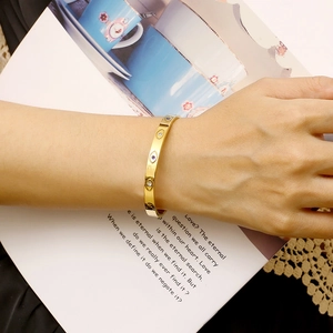 Chic 6mm gold-plated stainless steel evil eye bangle with crystals worn on a model