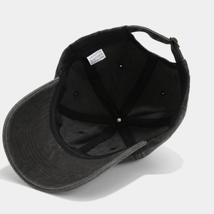 Detail view of the cotton baseball cap inner lining with 100% cotton tag and metal buckle