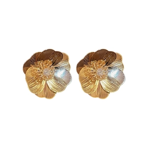 Golden flower stud earrings with crystal stamen and textured petals on white background
