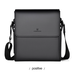 Detailed macro view of the black PU leather texture and brand logo on the front of the bag