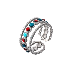 Detail of silver adjustable open ring featuring colorful red and blue beads with beaded texture